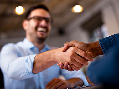 Man shakes hands with business employee