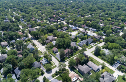 Bird's eye view of a suburban neighborhood with lots homes and greenery