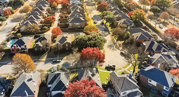 Bird's eye view of several beautiful homes with fall colored trees
