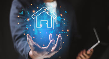 Creative image of man holding digital house in his hand