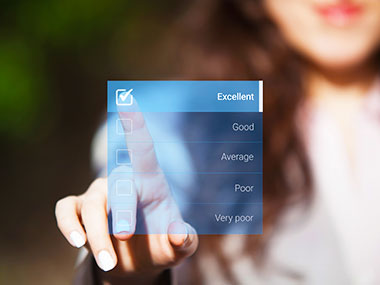 Woman using touchscreen to select the excellent option