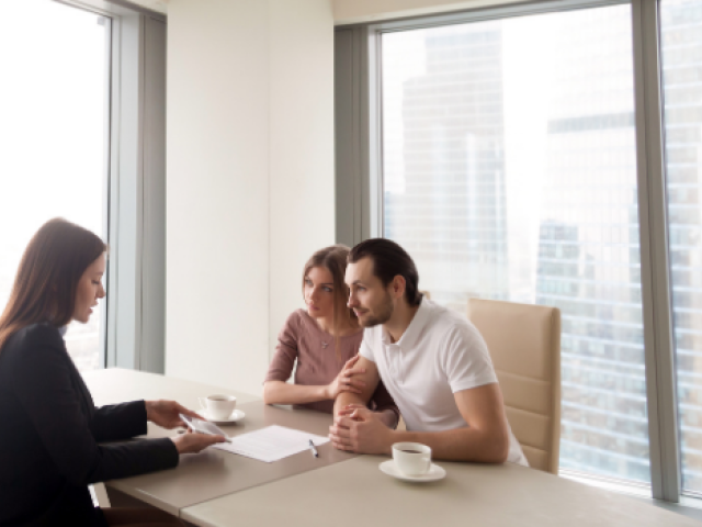 A couple consult with a professional woman in her office