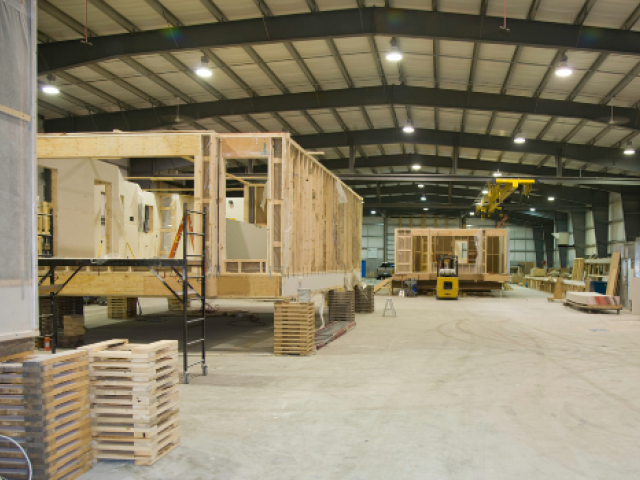 Manufactured homes being built inside a warehouse