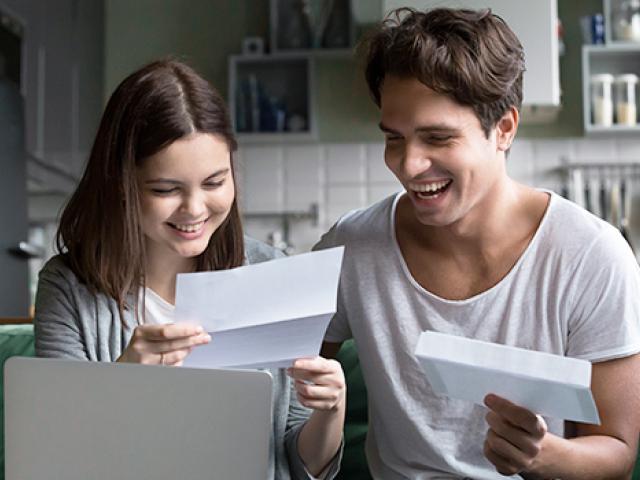 A couple are happy about a letter they received in the mail