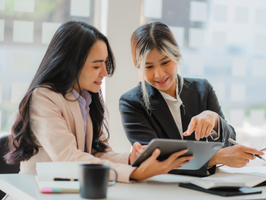 Two ladies looking at the laptop